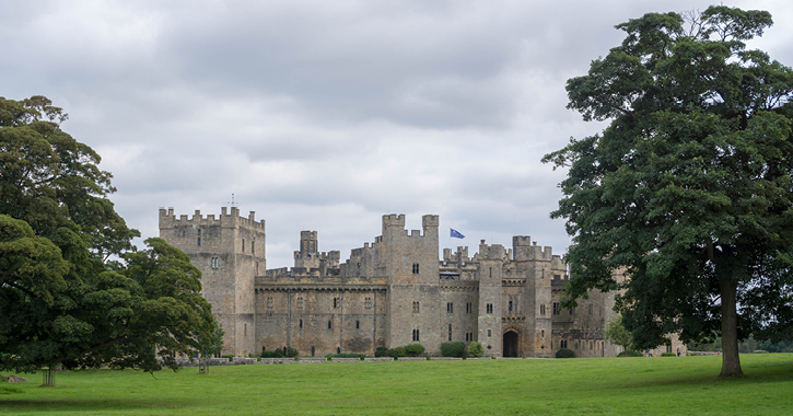 Raby Castle surrounded by the rolling green fields in the deer park